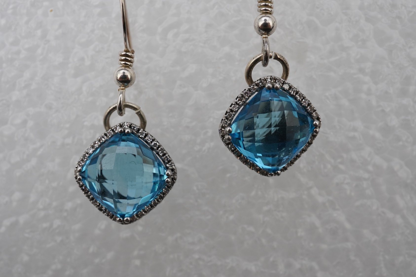 A pair of blue topaz and diamond pendant earrings